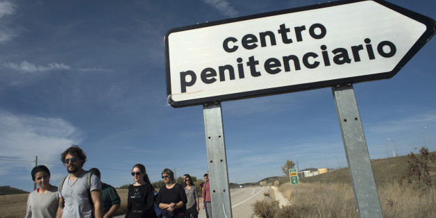 People gather for a demonstration outside the new and yet to open jail of Archidona, on November 26, 2017, where nearly 500 migrants who arrived in the country by boat last week are held.The Spanish government said that the migrants are held in Archidona´s jail due to a lack of space at immigration detention centres. Migrants who arrive in Spain by boat are usually initially detained in police facilities for identification and processing before being sent to an immigration detention centre wh