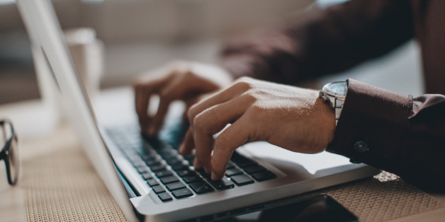 Hands typing on laptop computer
