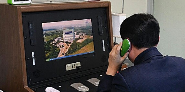PANMUNJOM, SOUTH KOREA - JANUARY 03: In this handout image provided by the South Korean Unification Ministry, A South Korean government official checks the direct communications hotline to talk with the North Korean side at the border village of Panmunjom on January 3, 2018 in Panmunjom, South Korea. North Korean media has reported that an inter-Korean communication line was reopened at the border village of Panmunjom on Wednesday in response to South Korea's unification minister Cho Myoung-gyo