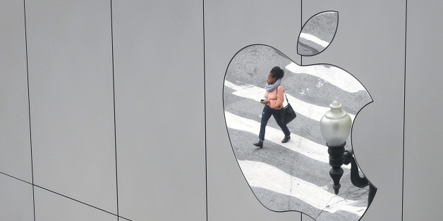 A woman is reflected in a Apple store logo in San Francisco, California, U.S., August 21, 2017. REUTERS/Kevin Coombs
