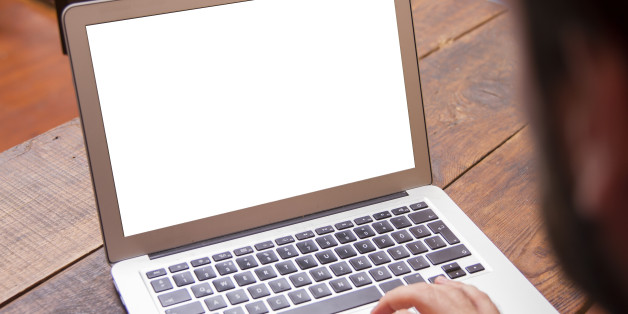 Businessman working on his laptop with copy space on a screen