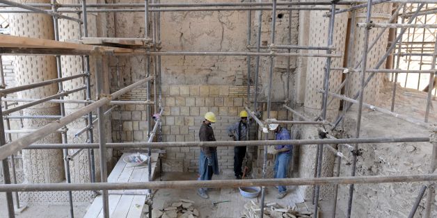 In this photograph taken on November 8, 2017 shows Afghan labourers working amidst scaffolding for the ongoing conservation work at the ninth-century mosque Masjid-e Haji Piyada (mosque of the walking pilgrim) in Balkh Province.In the white dusty plains of northern Afghanistan, archeologists and conservationists are seeking to unravel the secrets of an one of the oldest mosques in the world, whose structure is still standing after a thousand years of solitude. / AFP PHOTO / FARSHAD USYAN / To go