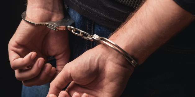 Close up of male hands in bracelets behind back