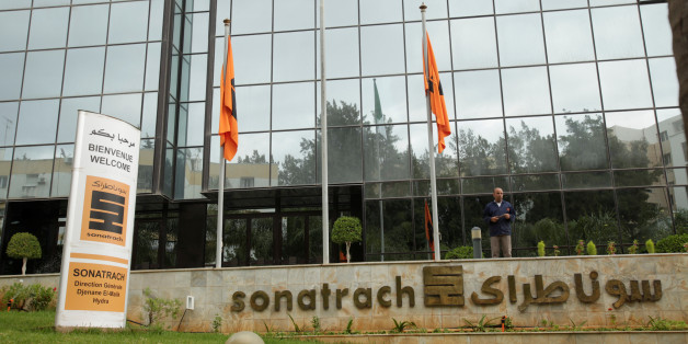 An employee stands near the headquarter of the state energy company Sonatrach in Algiers, Algeria june 26, 2016.Reuters/Ramzi Boudia
