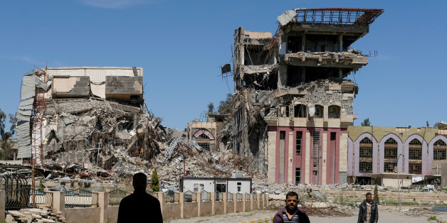 People walk in front of the remains of the University of Mosul, which was burned and destroyed during a battle with Islamic State militants, in Mosul, Iraq, April 10, 2017. Marko Djurica: "On April 10, a Reuters team entered eastern Mosul to work on a story about the the city's destroyed university, once a centre for education in northern Iraq. On arrival, I was struck first by the huge size of the campus, then by the scale of destruction. At least 10 large buildings and some smaller ones had be