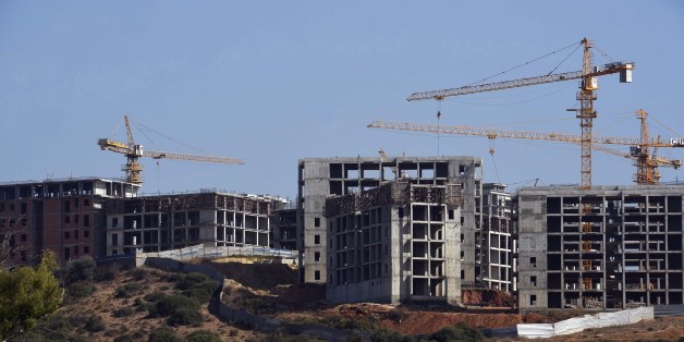 TO GO WITH AFP STORY BY ABDELLAH CHEBALLAH A photo taken on July 28, 2015 shows construction cranes in the Ain El-Malha suburb of the Algerian capital, Algiers. Faced with a burst in population growth, Algeria is constructing millions of properties with the hope to become the first African capital without any slums, but due to little urban planning these rapidly rising suburbs are at risk of turning into ghettos. AFP PHOTO / FAROUK BATICHE (Photo credit should read FAROUK BATICHE/AFP/Gett