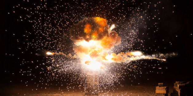Realistic fiery explosion busting over a black background