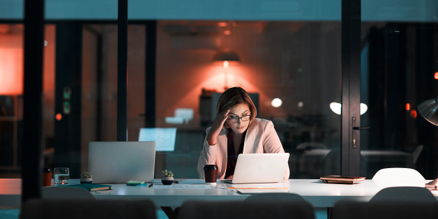 Shot of a businesswoman feeling worn out during a late night at work