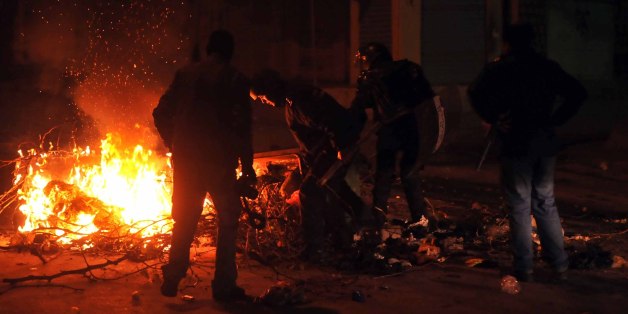 Tunisian police track down rioters in Ettadhamen on the outskirts of Tunis late on January 8, 2018 after price hikes ignited protests in the North African country. / AFP PHOTO / SOFIENE HAMDAOUI (Photo credit should read SOFIENE HAMDAOUI/AFP/Getty Images)