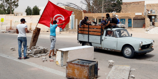 Protesters, who are demanding jobs and a share in revenue from the area's natural resources, react as they block the road which is usually used by foreign oil companies to go the oilfield in Tataouine, Tunisia May 12, 2017. Picture taken May 12, 2017. REUTERS/Zoubeir Souissi TPX IMAGES OF THE DAY