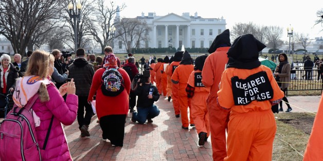 WASHINGTON DC, USA - JANUARY 12: Protesters, wearing orange prisoner jumpsuits, those symbolize Guantanamo Bay detainees, attend a protest in front of the White House in Washington D.C, United States on January 12, 2018. The protesters demanded the closure of the detention center at the U.S. Naval Base in Guantanamo Bay, Cuba on its 16th anniversary. (Photo by Safvan Allahverdi/Anadolu Agency/Getty Images)