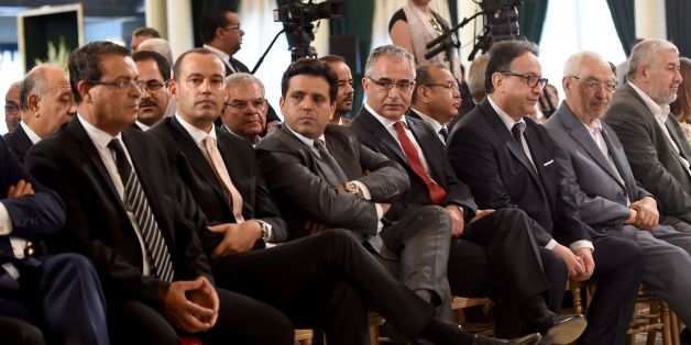Leaders of Tunisia's politics parties including leader of the Islamist Ennahdha party Rached Ghannouchi (2R), Nidaa Tounes party general secretary Hafedh Caid Essebsi (3R), former secretary-general of anti-Islamist Nidaa Tounes party Mohsen Marzouk(C), leader of the Free Patriotic Union (UPL) Slim Riahi (3L) and Afek Touis party president Yacine Ibrahim (2L) attend a ceremony for the signing of documents outlining the roadmap for the formation of a national unity government in Tunisia at the Car