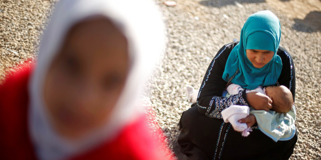 A displaced Iraqi woman, who fled the Islamic State stronghold of Mosul, holds a baby at Khazer camp, Iraq November 23, 2016. REUTERS/Mohammed Salem