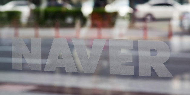Naver Corp. signage is displayed on a glass window at the company's headquarters in Seongnam, South Korea, on Tuesday, April 28, 2015. Naver, the parent company of Line Corp., operator of Japan's most popular instant-messaging platform, is scheduled to report first-quarter results on April 30. Photographer: SeongJoon Cho/Bloomberg via Getty Images