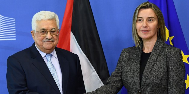 Palestian President Mahmoud Abbas (L) is welcomed by EU foreign policy chief Federica Mogherini prior to a meeting at the European Commission in Brussels on March 27, 2017. / AFP PHOTO / EMMANUEL DUNAND (Photo credit should read EMMANUEL DUNAND/AFP/Getty Images)