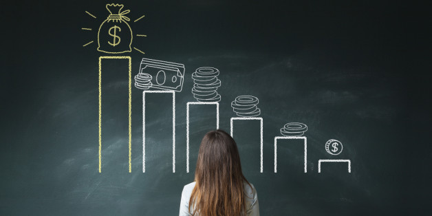 Business woman standing in front of a blackboard with a financial chart