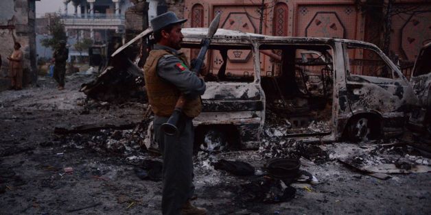 TOPSHOT - Afghan security forces inspect the site of attack on British charity Save the Children office in Jalalabad on January 24, 2018.Save the Children suspended operations across Afghanistan on WJanuary 24 as Islamic State militants terrorised staff trapped inside one of its offices in an hours-long attack, the latest assault on a foreign charity. Gunmen blasted their way into the British aid group's compound in the eastern city of Jalalabad, killing at least three people and wounding 24. /
