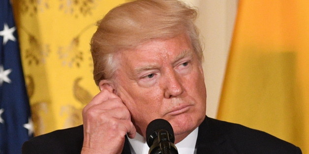 US President Donald Trump adjusts his translation ear piece during a joint press conference with Colombia's President Juan Manuel Santos at the White House on May 18, 2017 in Washington, DC. / AFP PHOTO / JIM WATSON (Photo credit should read JIM WATSON/AFP/Getty Images)