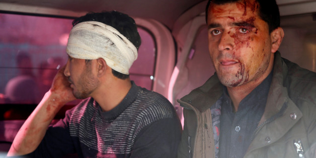 Injured men sit in an ambulance after a blast in Kabul, Afghanistan January 27, 2018.REUTERS/Mohammad Ismail