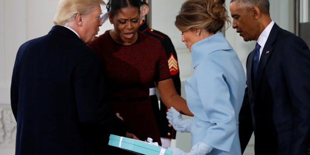 U.S. President-elect Donald Trump (L) and his wife Melania (3rd L) present a gift to U.S. first lady Michelle Obama and President Barack Obama as the Trumps arrive for tea before the inauguration at the White House in Washington, U.S. January 20, 2017. REUTERS/Jonathan Ernst