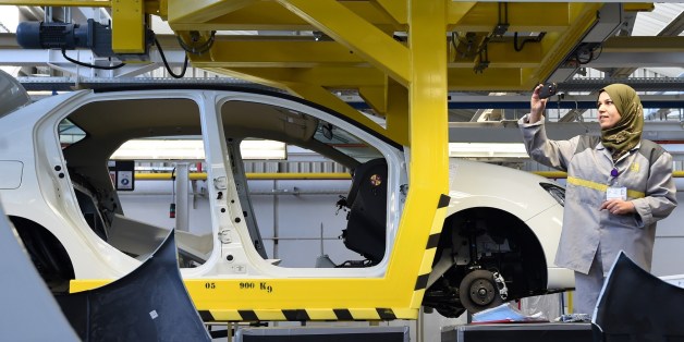 An employee of the French car maker Renault group takes a picture during the inauguration of a new production plant on November 10, 2014, in Oued Tlelat in the south of the Algerian city of Oran. The factory is to produce the Symbol, a saloon based on Renault's Clio compact sold mainly in markets where hatchbacks are not traditionally favoured. Production is destined for the Algerian market, Africa's second largest in terms of sales, with more than 400,000 vehicles imported every year. AFP PHOTO