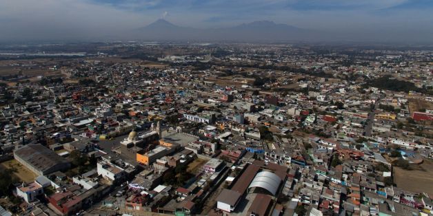 Aerial view of the municipality of Tenancingo, Tlaxcala state, Mexico with the Popocatepetl volcano in the background, on January 19, 2018.
The most powerful pimps of Mexico have virtually built walls around Tenancingo, the city where according to authorities, most of them were born. In Tenancingo, boys dream of becoming pimps and girls are treated like prostitutes.
/ AFP PHOTO / PEDRO PARDO (Photo credit should read PEDRO PARDO/AFP/Getty Images)