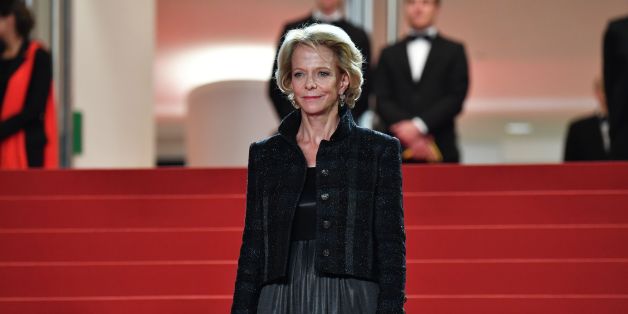 The President of the CNC Frederique Bredin looks at guests arriving on May 22, 2017 for the screening of the film 'Happy End' at the 70th edition of the Cannes Film Festival in Cannes, southern France. / AFP PHOTO / Alberto PIZZOLI (Photo credit should read ALBERTO PIZZOLI/AFP/Getty Images)