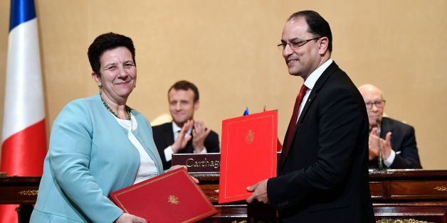 French Minister of Higher Education Research and Innovation Frederique Vidal (L) exchanges signed accords with her Tunisian counterpart Slim Khalbous at the Presidential Palace in Carthage on January 31, 2018. / AFP PHOTO / Eric FEFERBERG (Photo credit should read ERIC FEFERBERG/AFP/Getty Images)