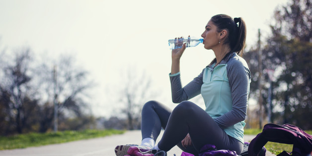 Fitness woman drinking water from bottle