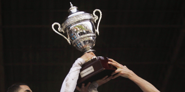 Algeria's Entente Setif players celebrate with the trophy after winning the African Super Cup soccer match against Egypt's Al-Ahly at the Mustapha Tchaker Stadium in Blida February 21, 2015. Entente Setif became the first Algerian club to win the African Super Cup after they edged out Egyptian giants Al Ahly in a dramatic penalty shootout on Saturday. REUTERS/Amr Abdallah Dalsh (ALGERIA - Tags: SPORT SOCCER)