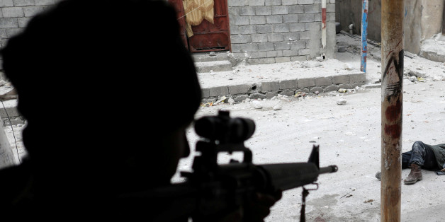 ATTENTION EDITORS - VISUALS COVERAGE OF SCENES OF DEATH OR INJURY An Iraqi special forces soldier shot dead an Islamic State suicide bomber in Mosul, Iraq, March 3, 2017. Goran Tomasevic: "The soldier is aiming at the dead body of ISIS suicide bomber. He killed him maybe 20-30 seconds before I started shooting pictures. We were in a house on the frontline since early morning. An ISIS fighter earlier killed an Iraqi Special Forces soldier and injured another one. The picture was shot in the eveni