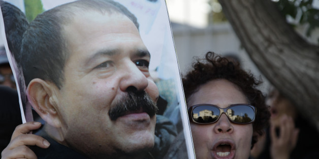 A Moroccan woman holds a picture of slain Tunisian secular opposition politician Chokri Belaid during a demonstration in front of the Tunisian embassy in Rabat February 8, 2013. REUTERS/Stringer (MOROCCO - Tags: CIVIL UNREST POLITICS CRIME LAW)