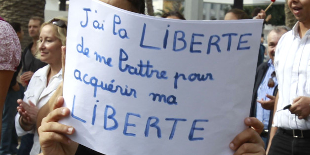 A boy holds a sign during a demonstration against hardline Salafists in Tunis, October 16, 2011. They are protesting against the violence which erupted when hundreds of hardline Salafists attacked the headquarters of Nessma TV station after it aired the film "Persepolis". The sign reads "I have the freedom to fight for my freedom". REUTERS/Zoubeir Souissi (TUNISIA - Tags: POLITICS CIVIL UNREST RELIGION)