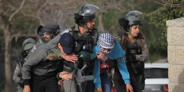 BETHLEHEM, WEST BANK - FEBRUARY 7: Israeli security forces take protesters under custody during a protest after Palestinian Ahmed Jarrar accused of killing an Israeli settler last month, was martyred by Israeli forces in the occupied West Bank, in Bethlehem, West Bank on February 7, 2018. (Photo by Mamoun Wazwaz/Anadolu Agency/Getty Images)
