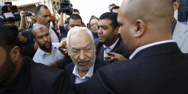 Rached Ghannouchi (C), leader of Ennahda Party, speaks to the media after a meeting, as part of a dialogue between ruling Islamists and the opposition, which aims to pave the way for the formation of a transitional government, in Tunis November 2, 2013. REUTERS/Zoubeir Souissi (TUNISIA - Tags: POLITICS)