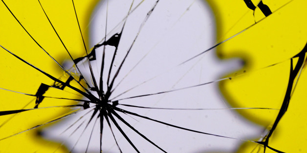 A Snapchat logo is seen through broken glass in this illustration picture, May 11, 2017. REUTERS/Dado Ruvic/Illustration
