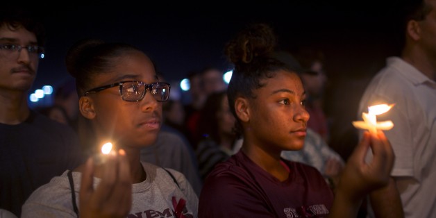 BROWARD, UNITED STATES - FEBRUARY 15: People hold candles as they gather at Pine Trails Park during a commemorative ceremony held for 17 people, who lost their lives in the school shooting at Marjory Stoneman Douglas High School, in Broward's Parkland, Florida on February 15, 2018. At least 17 people were killed on February 14, 2018, when a lone gunman opened fire on a Florida high school, according to police. The victims are a mix of students and adults, officials said. (Photo by Carlos Miller/