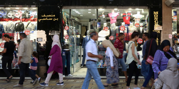 People walk past a clothes shop in Tunis, Tunisia, September 21, 2017 REUTERS/Zoubeir Souissi