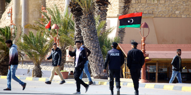 Libyans walk in Tripoli's Martyr square on February 15, 2018, two days ahead of the seventh anniversary of the Libyan revolution, which toppled strongman Moamer Kadhafi. / AFP PHOTO / MAHMUD TURKIA (Photo credit should read MAHMUD TURKIA/AFP/Getty Images)