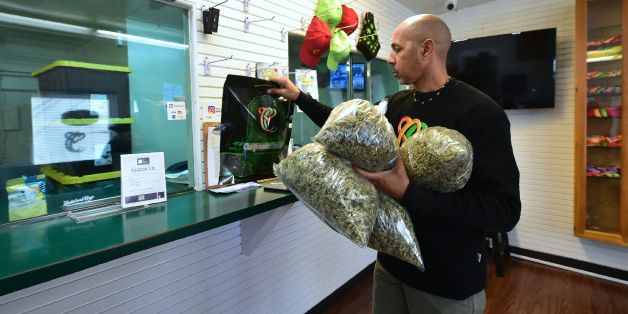 Cannabis entrepreneur Virgil Grant carries bags of medical marijuana at a dispensary he runs in Los Angeles, California on February 8, 2018.Virgil Grant is riding the high on California's cannabis legalization, with a burgeoning empire that already comprises three dispensaries, two plantations and a line of apparel. His success has come as some compensation for the six years lost inside the federal prison system for dealing the drug. / AFP PHOTO / Frederic J. BROWN / TO GO WITH AFP STORY by Vero