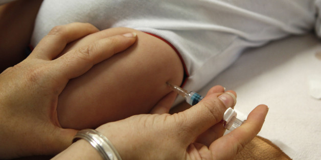 Six-month old Emilio Capone gets a vaccination at the clinic of paediatrician Thomas Fischbach in the western town of Solingen September 4, 2012. REUTERS/Ina Fassbender (GERMANY - Tags: BUSINESS EMPLOYMENT HEALTH)
