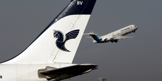 An Iranian Aseman Airlines' Fokker 100 takes off as an Iran Air aircraft is seen in the foreground at Tehran's international airport August 6, 2007. REUTERS/Morteza Nikoubazl (IRAN)