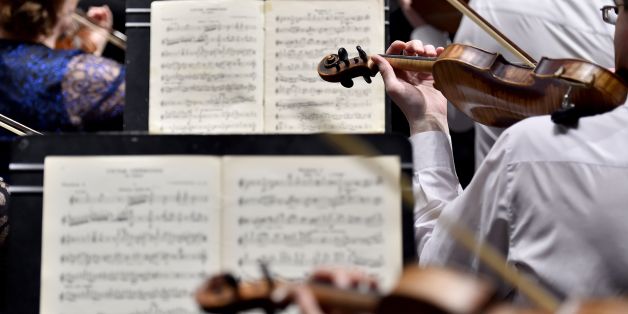 Musicians of the Ural Philharmonic Orchestra (Orchestre Philharmonique de l'Oural) rehearse the violin part of a musical piece composed by Russian composer Sergei Rachmaninoff and leaded by Russian director Dmitri Liss on the first day of 'La Folle Journee de Nantes' classic music festival, on January 31, 2018 in Nantes, western France. / AFP PHOTO / LOIC VENANCE (Photo credit should read LOIC VENANCE/AFP/Getty Images)