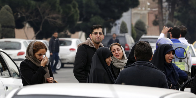 Relatives of Iranian passengers, onboard the Aseman Airlines flight EP3704, react as they gather in front of a mosque near Tehran's Mehrabad airport on February 18, 2018. All 66 people on board an Iranian passenger plane were feared dead after it crashed into the country's Zagros mountains, with emergency services struggling to locate the wreckage in blizzard conditions. / AFP PHOTO / ATTA KENARE (Photo credit should read ATTA KENARE/AFP/Getty Images)