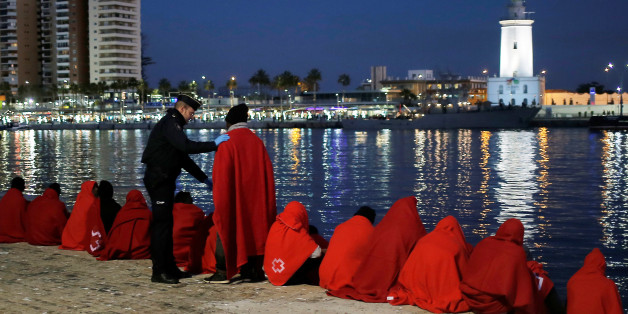 A migrant, part of a group intercepted aboard a dinghy off the coast in the Mediterranean Sea, talks to a Spanish police officer after arriving on a rescue boat at the Port of Malaga, Spain December 7, 2017. REUTERS/Jon Nazca