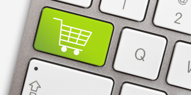 Computer keyboard with green key and shopping cart
