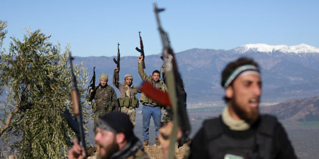 Turkish-backed Free Syrian Army fighters react as they hold their weapons near the city of Afrin, Syria February 19, 2018. REUTERS/Khalil Ashawi