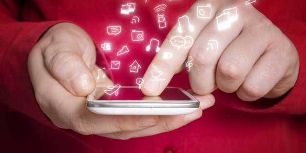 Smart phone. Hand holding smart phone with various hand drawn social media icons.