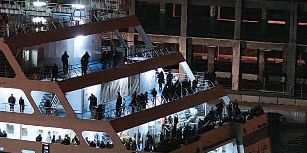 Passengers from the Algerian ferry 'Tariq Ibn Ziyad' wait onboard 15 December in Marseille, southern France, after their boat, en route to Algiers, returns to the French harbour, due to a bomb alert. The ferry belongs to 'Algerie ferries' company. Some 1.400 passengers wait to be evacuated. AFP PHOTO BORIS HORVAT. (Photo credit should read BORIS HORVAT/AFP/Getty Images)