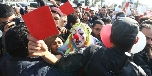 TUNIS, TUNISIA - JANUARY 26: A demonstrator, wearing a clown costume, from Tunisia's 'Fech Nestannew' (What are we waiting for?) youth movement attends a protest against high cost of living after the new budget law outside the Parliament building in Tunis, Tunisia on January 26, 2018. (Photo by Yassine Gaidi/Anadolu Agency/Getty Images)